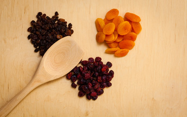 Dried fruits raisins apricots cranberries on table