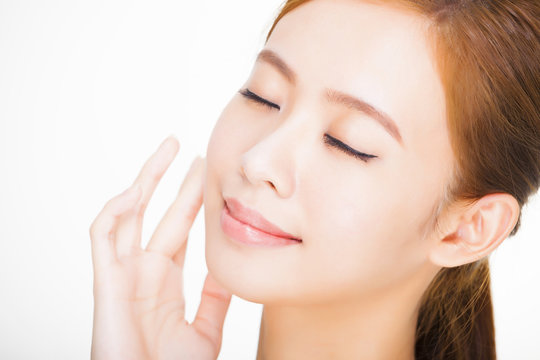 Beautiful face of young adult woman with clean fresh skin. skin