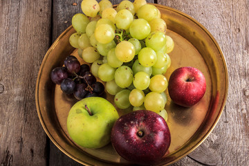 close up of fresh organic fruits on yellow copper metal tray