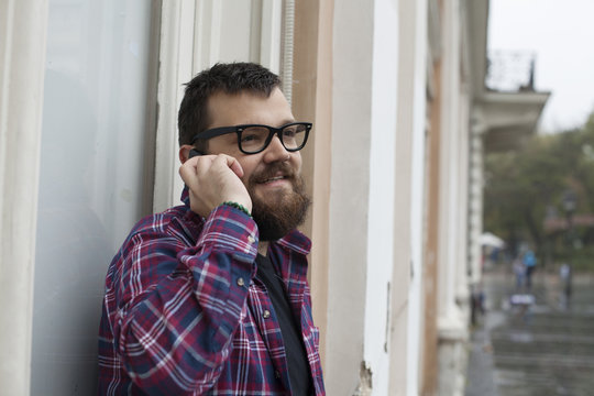 Man With Beard And Glasses Talking On Mobile phone