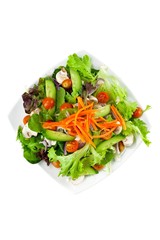Plate of vegetable salad on white