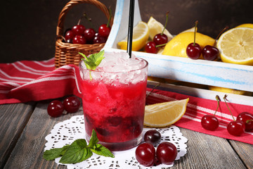 Fresh cold cherry cocktail with mint, ice and lemon