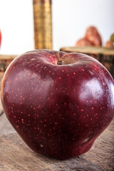 Really red apple on gray old wooden table