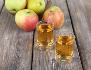 Still life with tasty apple cider in barrel and fresh apples