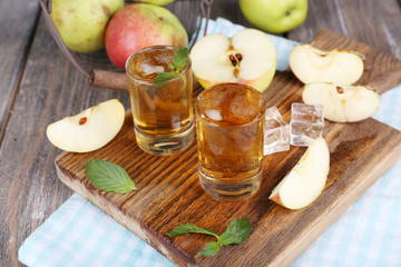 Still life with tasty apple cider in barrel and fresh apples