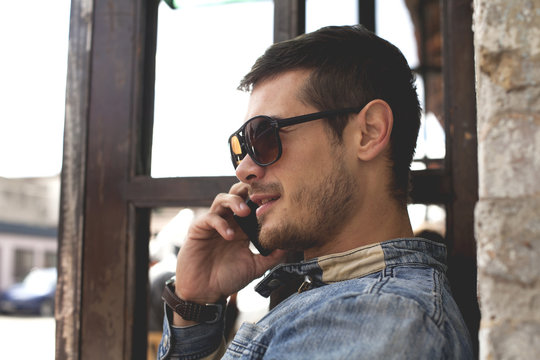 Attractive Young Man Talking On The Mobile Smart Phone