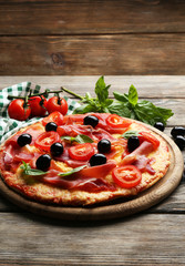 Delicious pizza served on wooden table