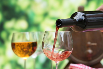 Red wine pouring into wine glass, close-up