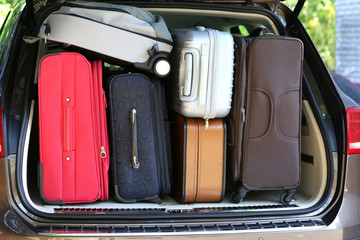 Suitcases and bags in trunk of car ready to depart for holidays