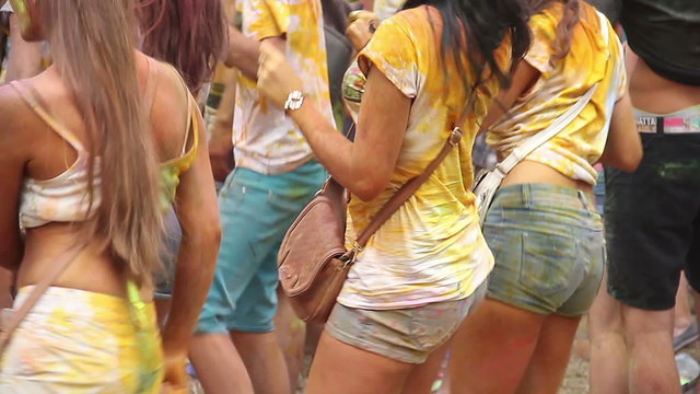 Beautiful girls dancing to music at party, crowd enjoying fest