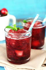 Closeup of cherry granita in glasses, on color wooden
