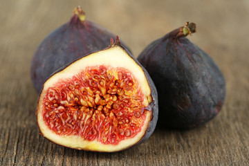 Ripe sweet figs on wooden background