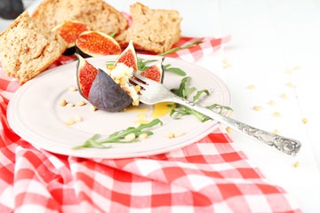 Ripe sweet fig with cottage cheese and honey, on plate