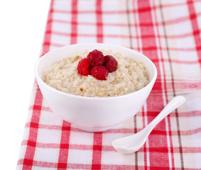 Tasty oatmeal with berries on napkin close-up