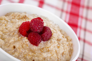 Tasty oatmeal with berries on napkin close-up