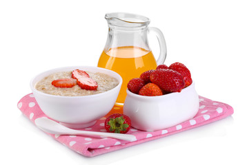 Tasty oatmeal with berries and juice isolated on white