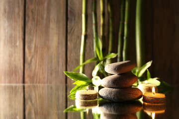 Fototapeta na wymiar Spa stones, candles and bamboo branches