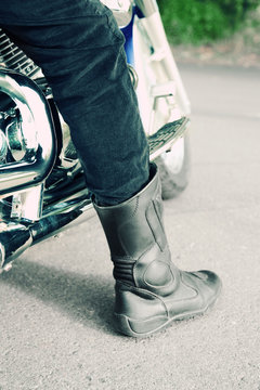 Bikers boot on open road, close-up
