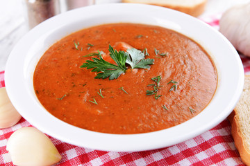 Delicious lentil cream-soup on table close-up