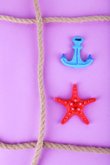 Fototapeta na wymiar Sea souvenirs on purple background