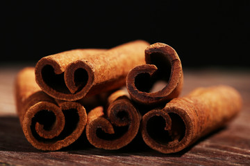 Cinnamon sticks on table on dark background