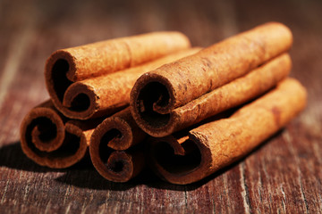 Cinnamon sticks on wooden background