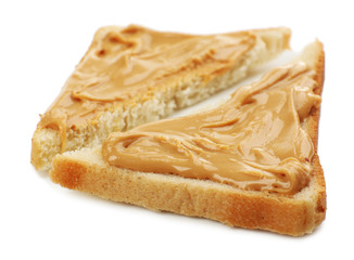 Slices of bread with creamy peanut butter, isolated on white