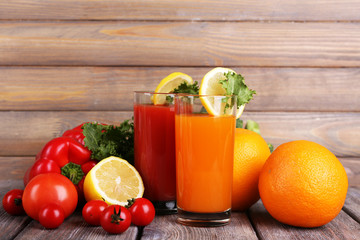 Carrot and tomato juice in glasses and fresh vegetables
