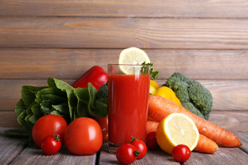 Tomato juice in glass and fresh vegetables