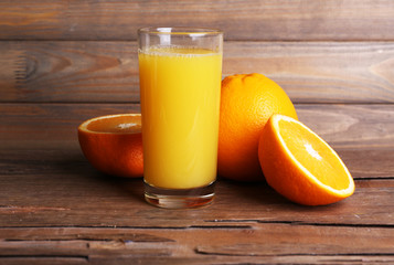 Glass of orange juice and fresh oranges