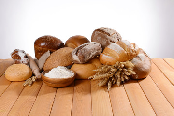Fresh bread on table on white background