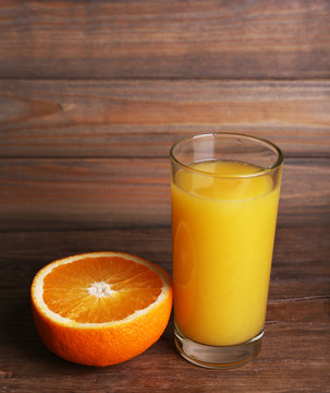 Glass of orange juice and fresh orange