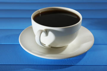 Cup of coffee on wooden table