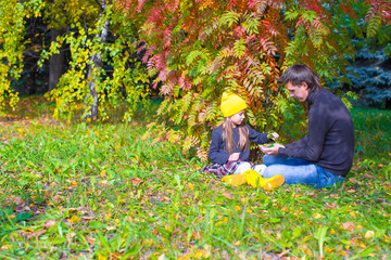 Naklejka na ściany i meble Father with cute daughter in autumn park outdoors