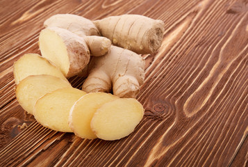 Ginger root sliced on wooden table