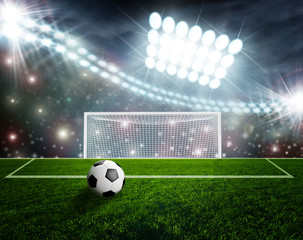Soccer ball on green stadium arena