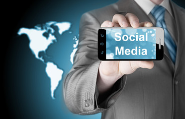 business man hand holding smartphone with Socail Media