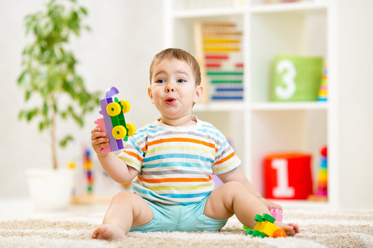 kid boy playing with block toys indoors