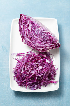 Shredded red cabbage on white plate