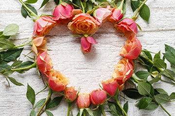 Pastel pink roses on wooden background
