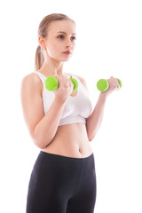 Athletic woman pumping up muscles with dumbbells