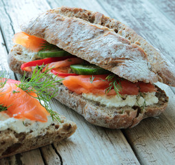 Sandwich with smoked salmon and fresh vegetables