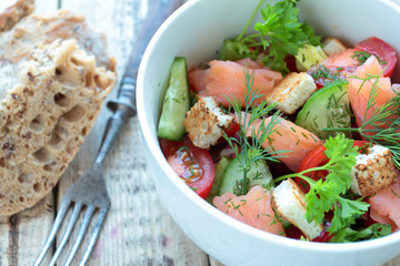 Smoked salmon salad with vegetables and fresh herbs
