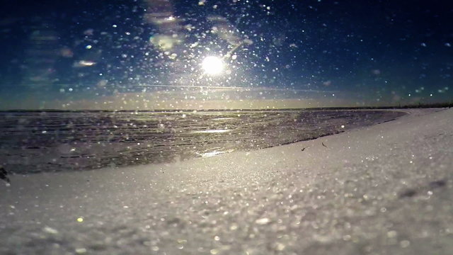 Frozen sea coast:  Snow blizzard during Bright sunny day