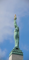 Figure of Liberty lifting three gilded stars (Riga, Latvia)