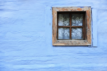 Old wooden window on blue wall