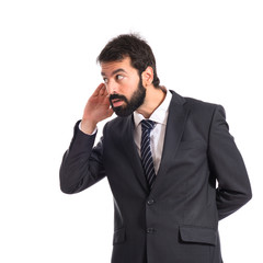 Fototapeta premium Businessman listening over isolated white background