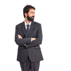 Businessman with his arms crossed over white background