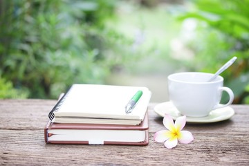 Notebook  and coffee on wooden table