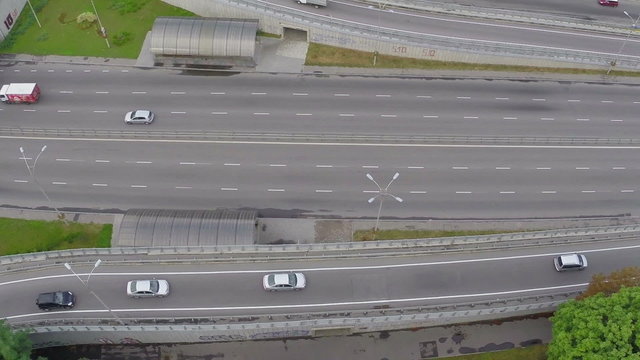 Fast-driving car traffic  on city highway, view from above